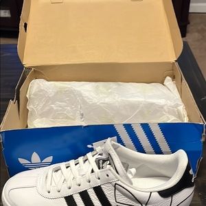 Adidas tennis shoes color white and black size 10